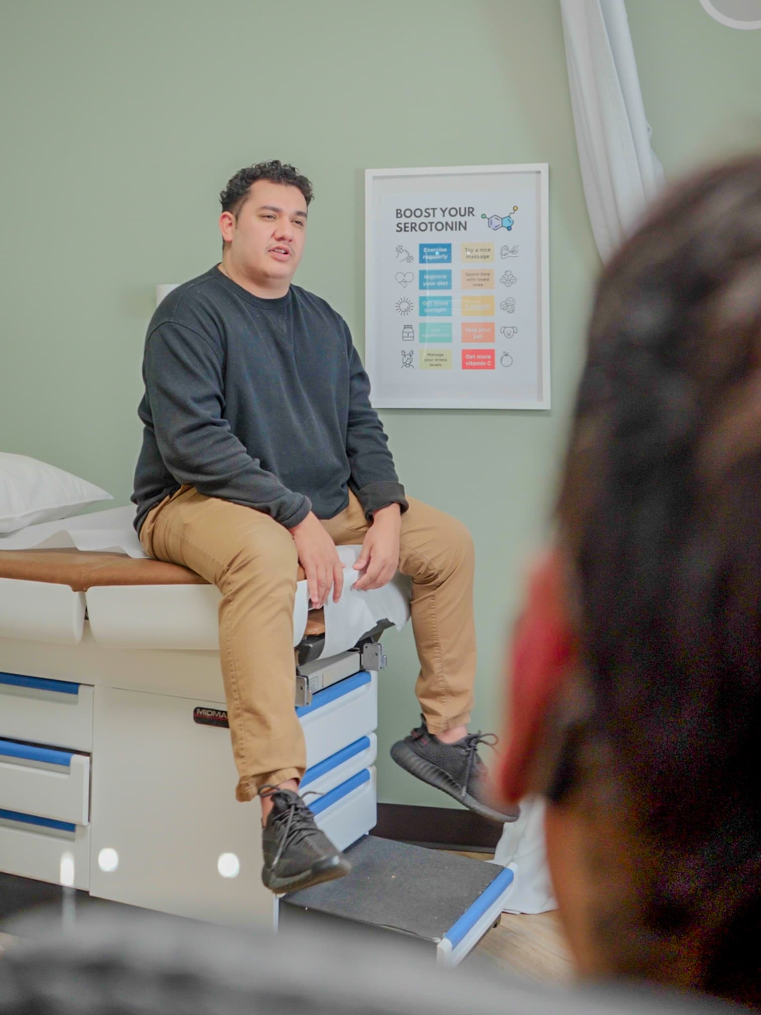 A patient sitting up on an exam-room bed at Fort Wayne Direct Primary Care