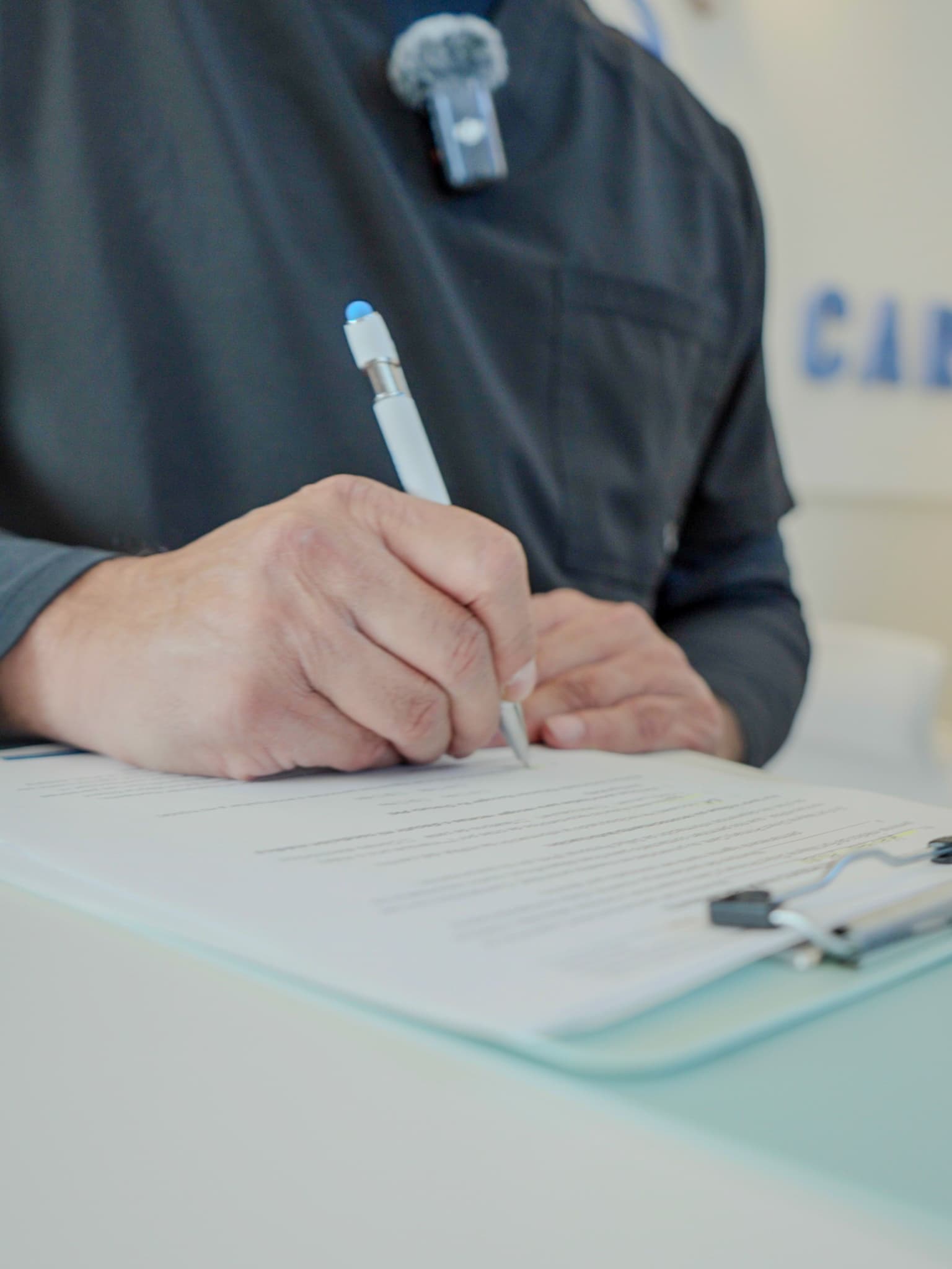 Dr. Aluri writing in a patient chart